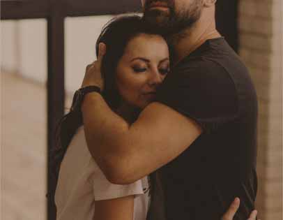 Separated husband and wife reconnecting with a long hug after months of personal growth